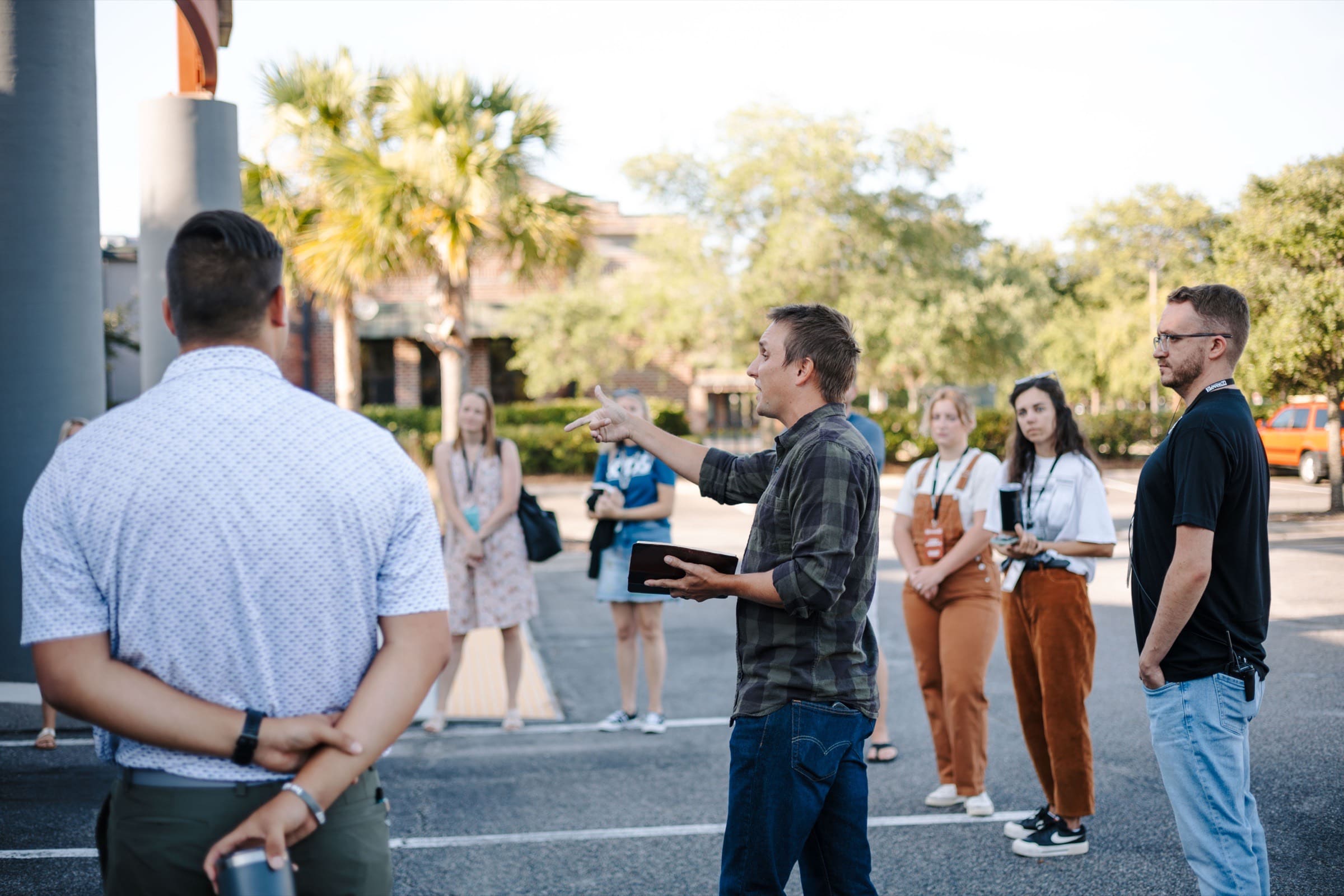 A leader briefing a team outside an Eleven22 campus