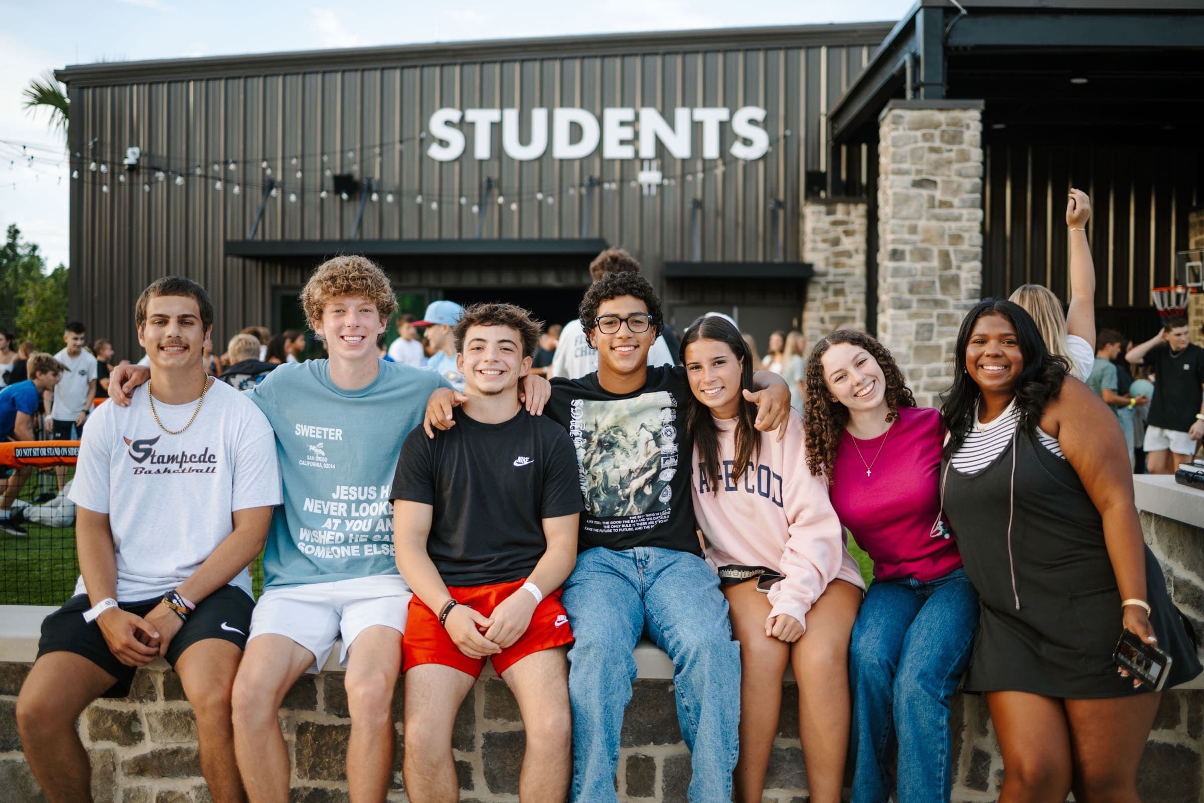 Eleven22 students smiling outside the Students building