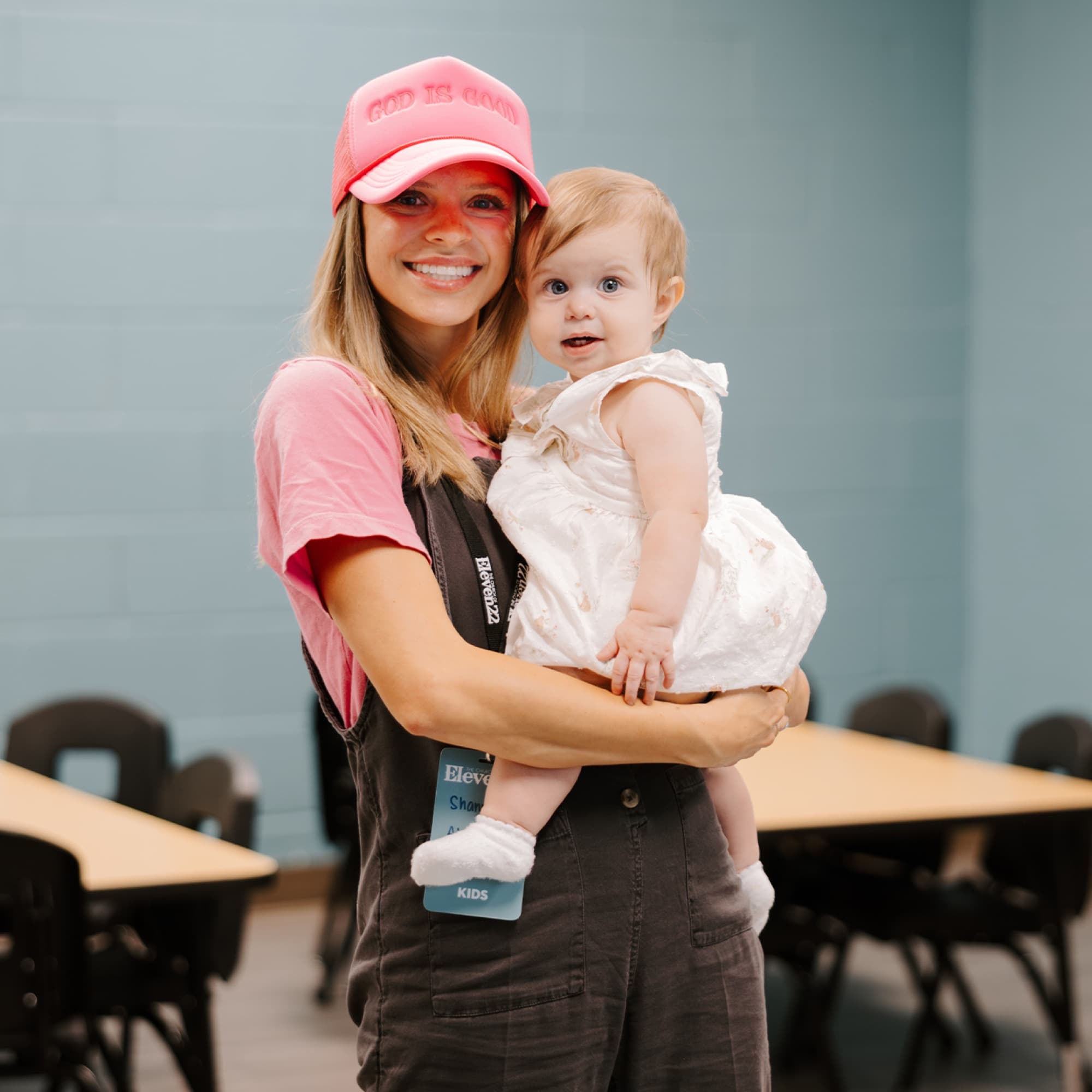 Smiling resident holding a baby